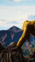 Vertical Clumsy adventurer finds himself at the mercy of the wind struggling to keep balance, falling off of a mountain top. The cold weather proves unforgiving for unprepared hiker. Camera A. video