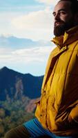 Vertical Hiker embraces the challenge of trekking through the wilderness, enjoys panoramic mountain landscape as a reminder of strength and the rewards of outdoor adventure. Adventure seeker. Camera A. video