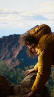 Vertical Clumsy hiker tripping and falling off of a mountain peak cliff, leading to an accident due to lack of attention. Inconsiderate unprepared traveler stumbles on unstable terrain. Camera B. video