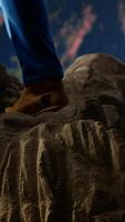 Vertical Young trekker enjoys peaceful moment in the wilderness with epic view, surrounded by towering mountain peaks and an open sky. Adventure seeker at high altitude, conquering fears. Camera B. video