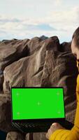 Vertical Trekker takes in the panoramic landscape next to isolated mockup screen, where the peaceful mountain scenery and open sky symbolize adventure and perseverance. Wanderlust. Camera A. video