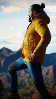 Vertical Young traveler enjoys the serenity of the high altitude wilderness, stunning landscape and peaceful surroundings. Nature lover e feeling happy climbing to the mountain top. Camera A. video