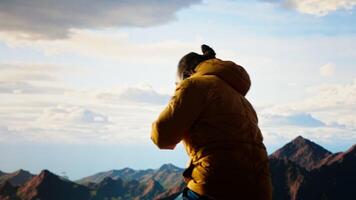 Careless hiker tries to make a phone call on the mountain top and falling off a cliff, causing the accident due to his obsession with technology and always staying connected. Camera B. video