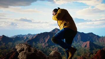 Careless hiker tries to make a phone call on the mountain top and falling off a cliff, causing the accident due to his obsession with technology and always staying connected. Camera A. video