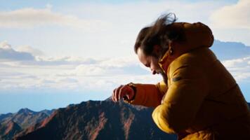 Hiker battling strong winds and cold weather tumbles over a cliff on the mountain top, dangerous risky place for trekking. Unprepared adventure seeker being foolish and tripping. Camera B. video