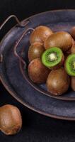 Ripe kiwi fruits arranged on a dark, rustic metal tray, creating a visually appealing presentation video
