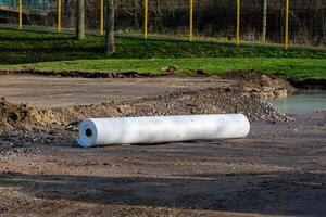 Rolled white materials laid for site preparation and landscaping photo