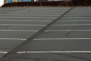 Parking lot with empty spaces and clear lines during daylight photo