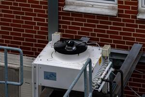 Industrial cooling unit on rooftop during daylight hours photo