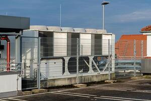 Rooftop cooling system with safety fencing during daylight photo