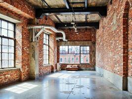 An empty room with brick walls and windows photo