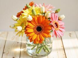 A vase filled with colorful flowers on a wooden table photo