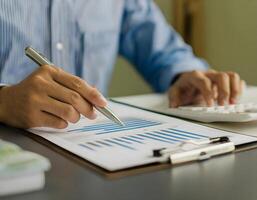 Man Working on Finance Calculations at Home Office Desk photo