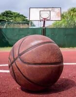 Close-up of a Basketball on a Red Playing Surface photo