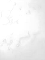 A white wall with a large crack in it photo