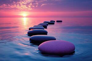 Large smooth stones lie in the sea at sunset, creating a path. The concept of harmony and balance. photo