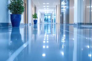 Potted plants, clean shiny floor, blurred space. Modern bright interior of an office or medical center with a long corridor. photo