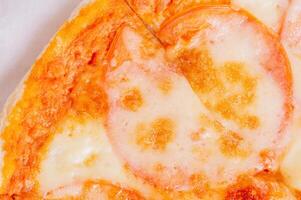 Pizza macro photo with tomatoes, sauce and cheese. Pizza delivery.