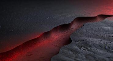 Subtle and evocative abstract backdrop created by red light blending into black on a textured surface. photo