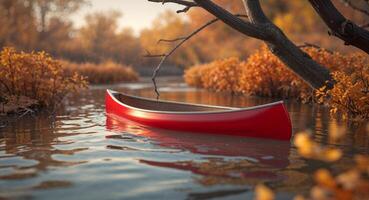 Red canoe floating on the river in autumn photo