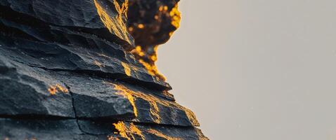 A close up of a rock wall with orange light photo