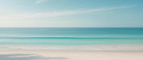 A beach with a blue ocean and white sand photo