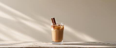 Iced Cinnamon Drink in Glass on Wood Table photo