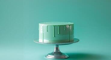 A green cake with a drip of icing on top photo