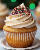 A delicious cupcake with vanilla frosting and colorful sprinkles photo