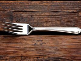Silver fork on a rustic wooden table photo