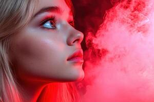 Womans face illuminated by red light and smoke photo
