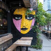 A vibrant mural of a face adorns a building exterior, adding an artistic touch to the urban landscape photo