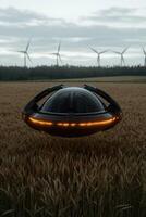 UFO hovering over a wheat field with wind turbines in the background photo