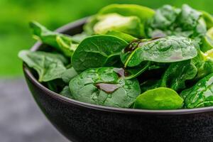 Fresh spinach salad with balsamic vinaigrette in a bowl photo