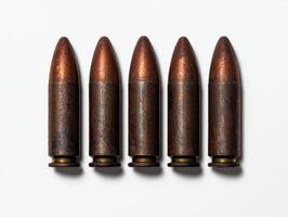 Five old bullets in a row on a white background photo