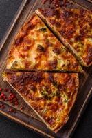 Delicious fresh quiche with broccoli, cheese, spices photo