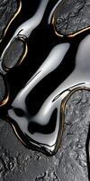 Abstract black liquid with gold accents on a textured surface photo