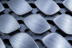 Metal textured objects arranged on a grid photo