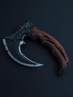 A curved knife with a wooden handle on a black background photo