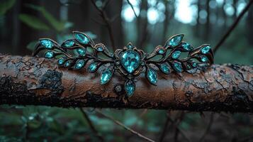 A beautiful crown with blue gems rests on a tree branch photo
