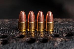 Ammunition in a row on a textured surface photo