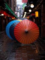 Colorful umbrellas line a wet street in the rain photo