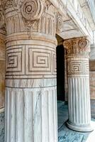 Close up of ornate marble columns with spiral details and geometric patterns photo