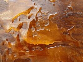 Close up of amber resin on wood surface photo