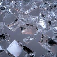 Shards of broken glass on a reflective surface photo