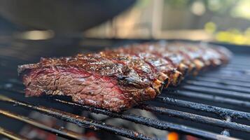 Juicy marinated steak is cooking on a barbecue grill in a backyard setting, with friends enjoying the sunny afternoon during a leisurely cookout. photo
