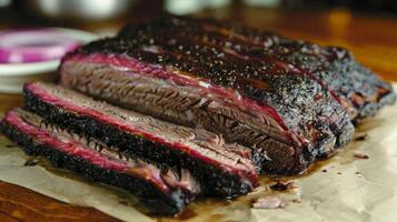 A mouthwatering display of perfectly smoked brisket, sliced into tender pieces and resting on butcher paper. Accompanied by pickles and onions, perfect for barbecue lovers. photo