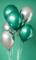 Elegant Green and Silver Balloons Floating Against a Soft Teal Background Setting photo