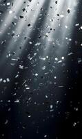 Abstract festive background with falling silver confetti and sparkling light rays effect photo