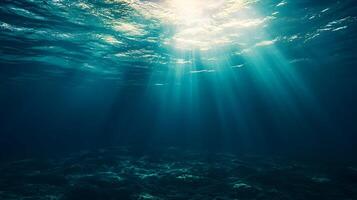 Sunlight filtering through deep ocean water, creating serene underwater atmosphere photo